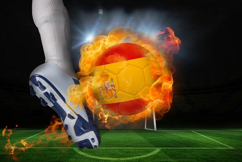 A foot kicking a fire ball colored like the Spanish flag